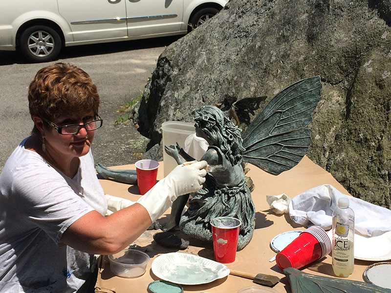 Debbie Farrand, interior designer at Dressing Rooms, restoring a sculpture.